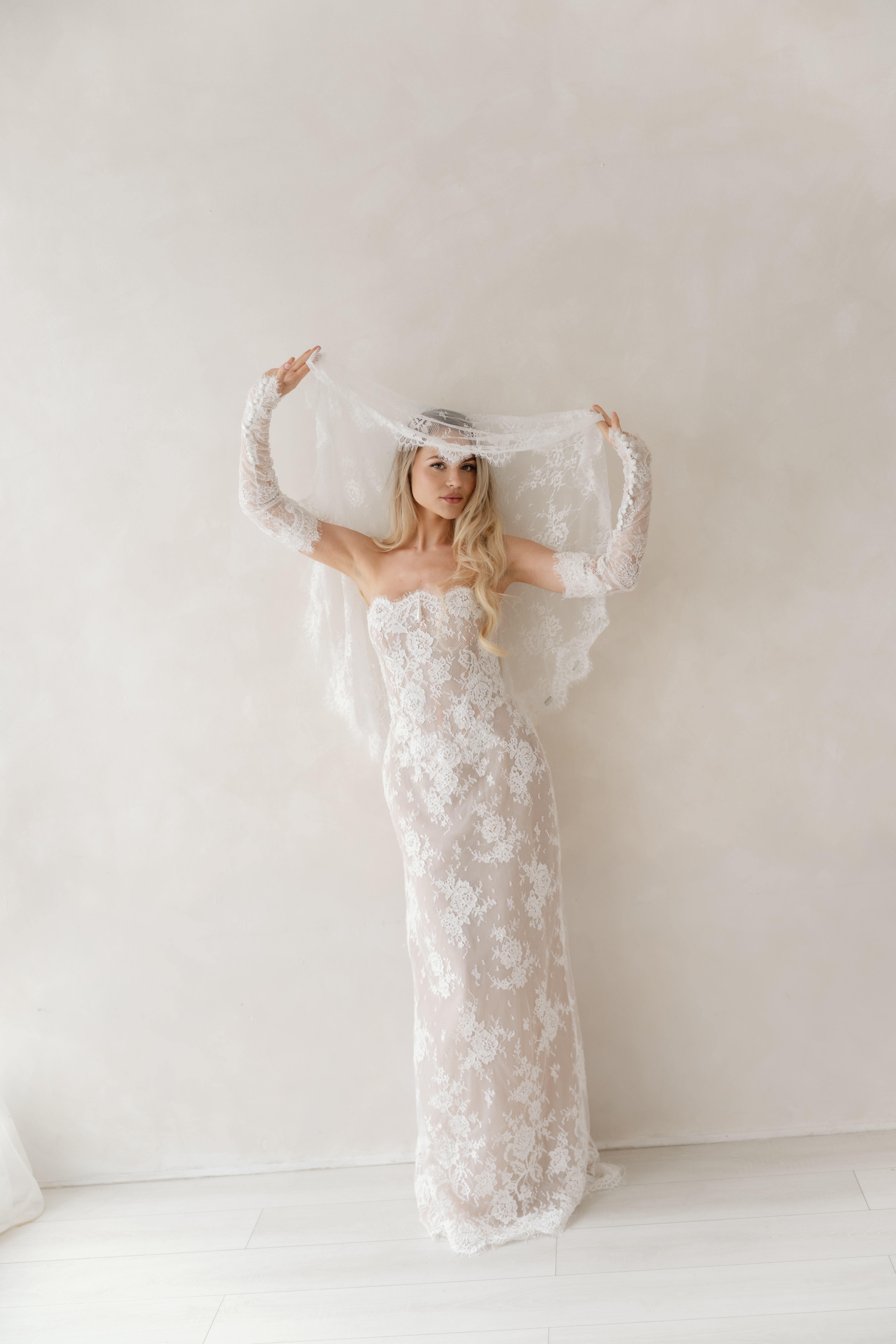 Bride lifting her lace veil