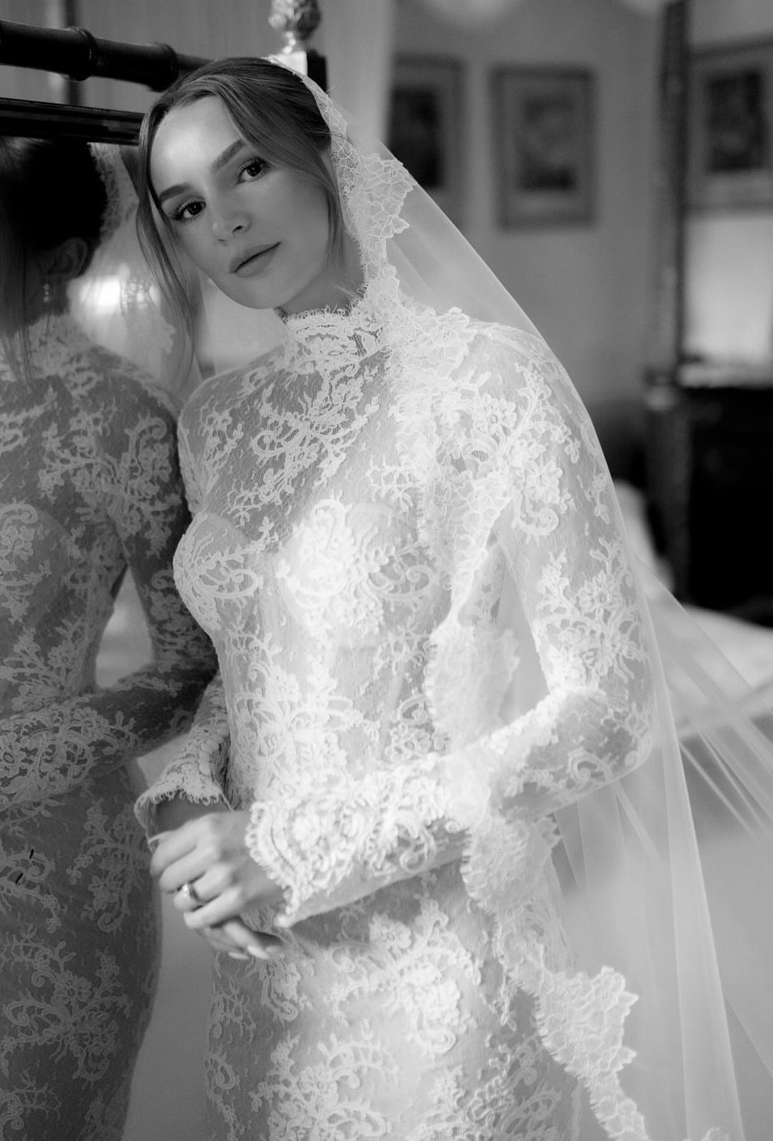 Bride in lace gown with veil, black and white