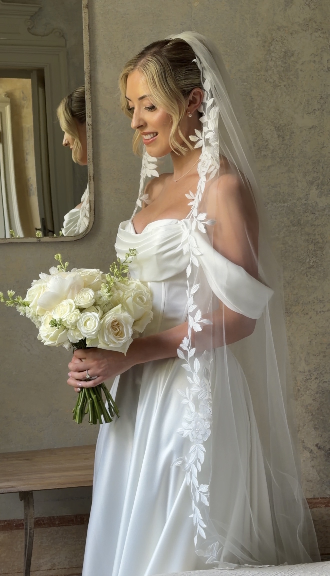 Bride with floral veil and bouquet, Italy