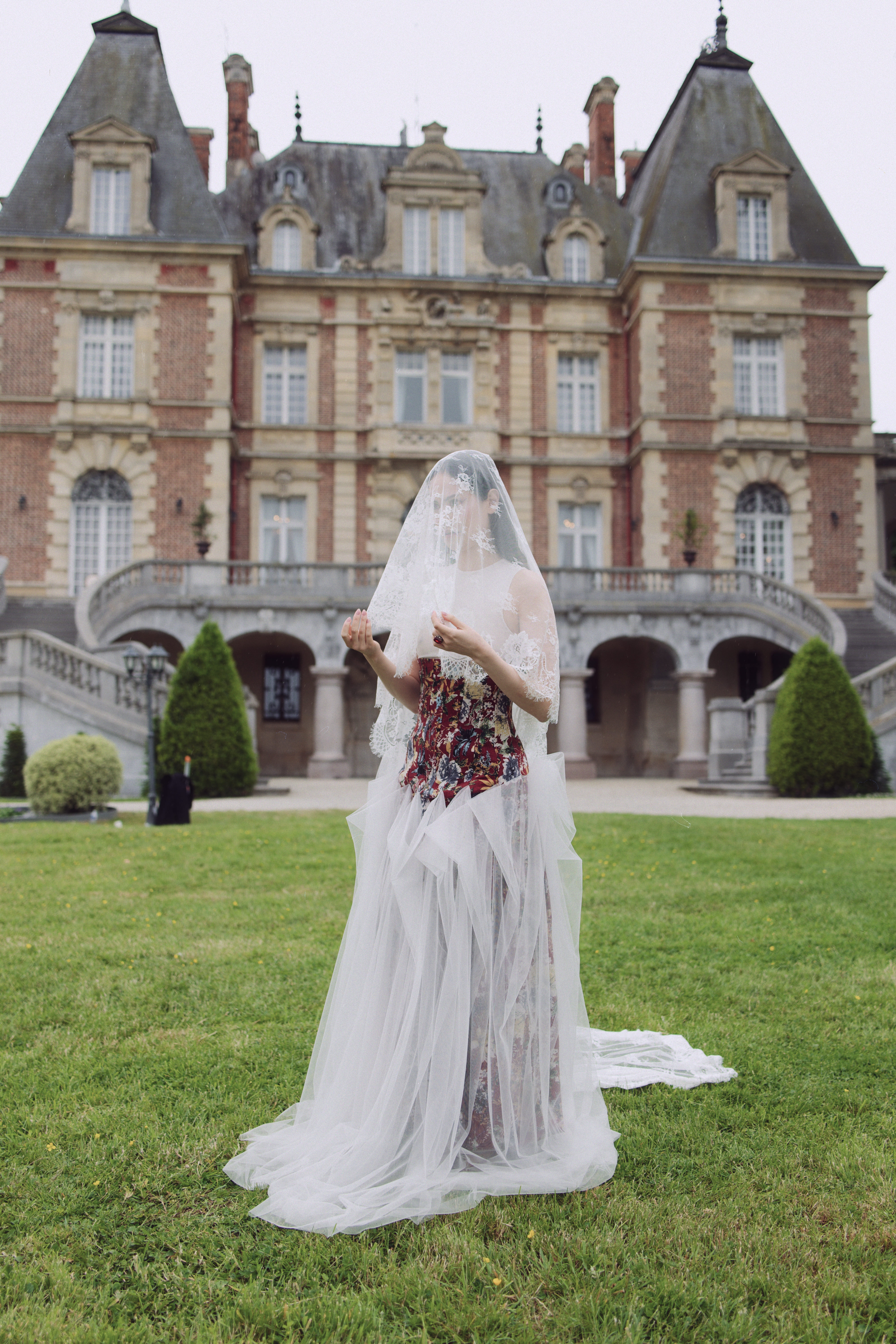 Editorial bride in veil before French chateau