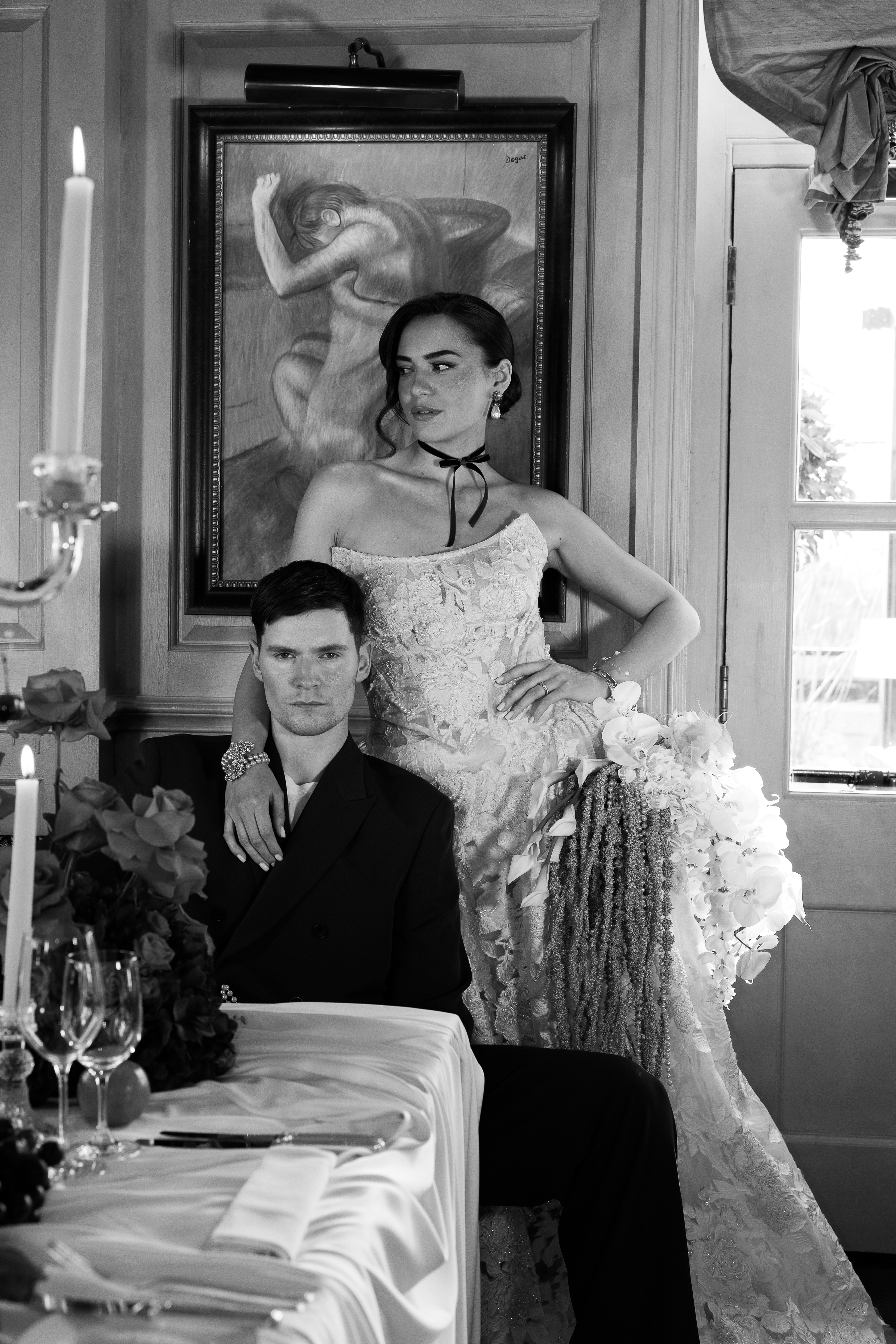 Couple at candlelit table, editorial B&W